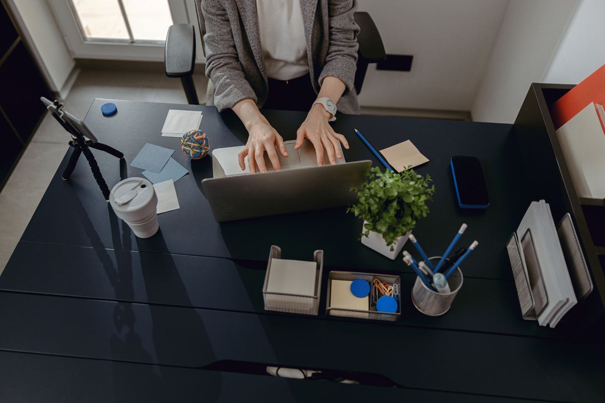 Overhead view of a person working at a tidy desk