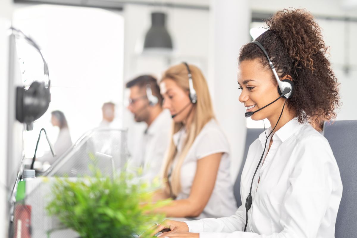 Customer service agent wearing a headset in a bright office
