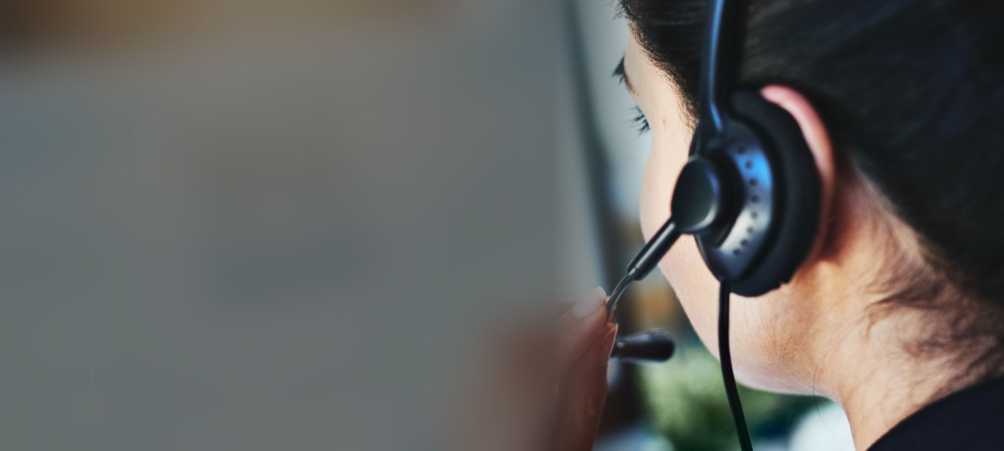 Person wearing a headset speaking into the microphone